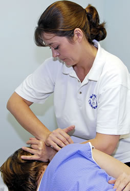 Karen Ambrose demonstrating a chiropractic treatment